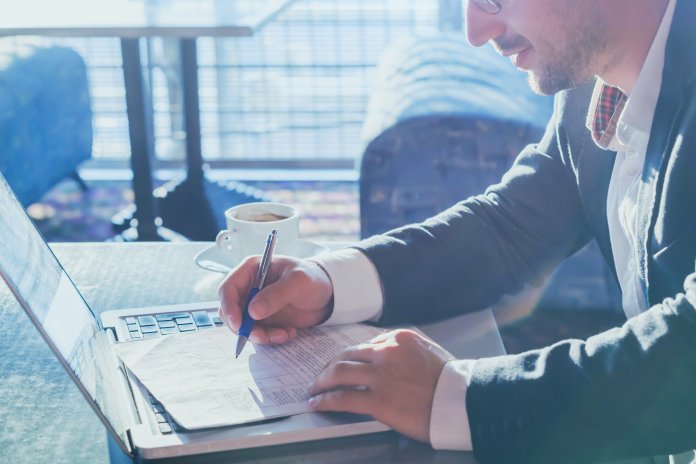 business entrepreneur man working with computer and paper documents