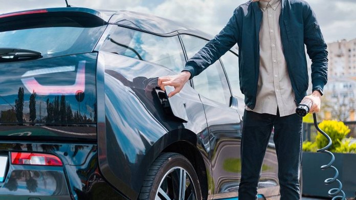 Man charging electric car